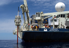 The Grapple swings the big core around to the stern of the Knorr for more rigging.