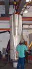 Corehead under construction at WHOI.  Tubular inner assembly comprised of variable weight compartments is shown being lowered into main shell.