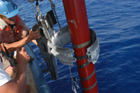 Barrel clamps are reconnected and lowered into place on pre-cut lanyards.