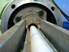After the core is secured, extrusion begins by loading plastic pushrods into the extruder breach.