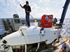 Working on the deck of the research vessel Atlantis, pilots and technicians from the Alvin Group scrub down the submersible between dives.