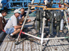 Aboard the Bulgarian R/V Akademik, research specialist Alan Gagnon (in the hat) and Bulgarian scientists inspect Niskin bottles during a Black Sea cruise with Assistant Scientist Marco Coolen. 