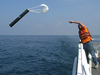Dave Morton throwing overboard a sonobuoy hydrophone receiver.
