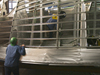 Workers at Gladding-Hearn Shipbuilding assemble the aluminum hull of Tioga.