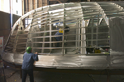 Workers at Gladding-Hearn Shipbuilding assemble the aluminum hull of Tioga.