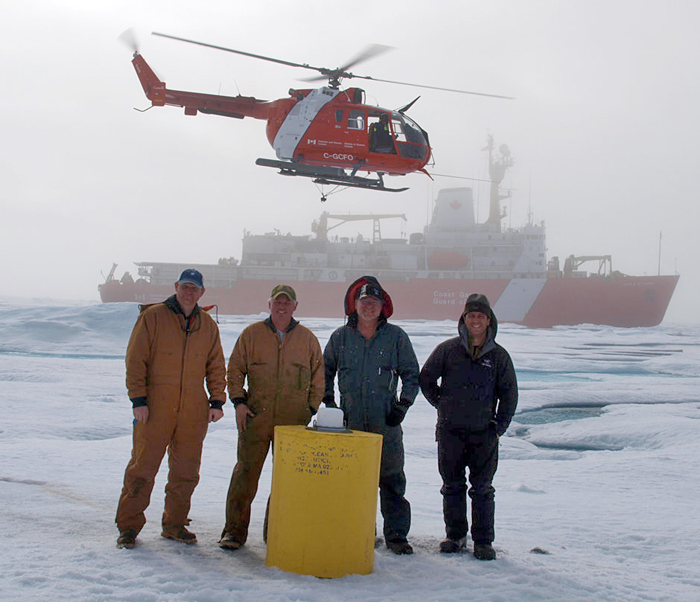WHOI researchers and engineers pose next to float of an ice-tethered profiler they just deployed in the Beaufort Sea