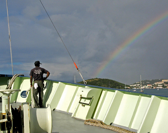 Bosun Clindor Cacho admires a rainbow as the Oceanus prepares to dock at St. Thomas