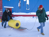 Kris Newhall and John Toole toting the ITP on a sled through the snow.