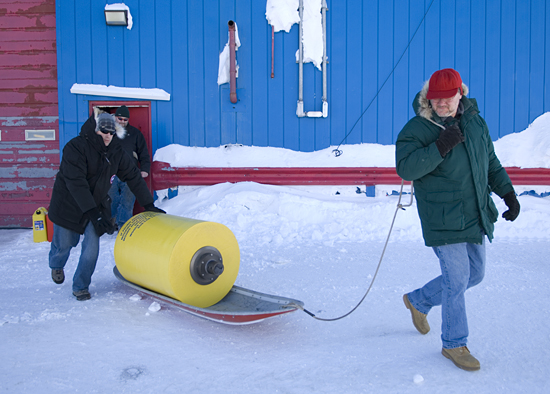 Kris Newhall and John Toole toting the ITP on a sled through the snow.