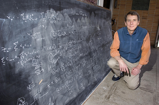 Gene Terray with uncovered blackboard.