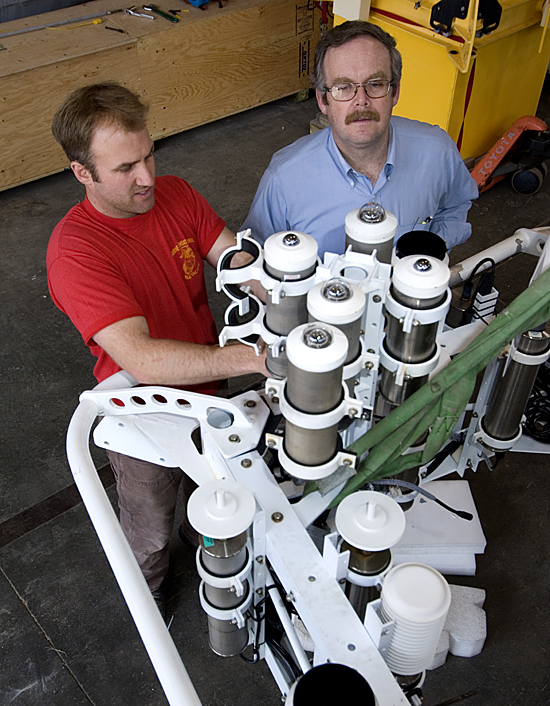 Under the observing eye of Senior Scientist Bob Weller, Engineering Assistant Sean Whelan removes sensor instruments from the CLIMODE buoy.