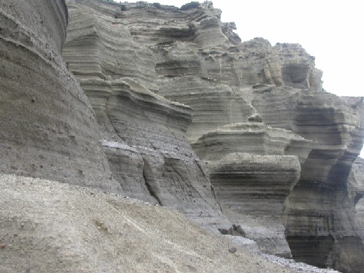 The layers that make up the cone represent individual eruptive pulses and discrete hydrovolcanic explosions.