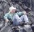 Adam Soule sits on his throne of lava, the undisputed king of his domain. The lava in the background has formed during the two decades of volcanic activity during the current eruption. Lava falling streams down the cliff in narrow pahoehoe toes that build, one on top of the other, producing this beautiful carapace of lava.