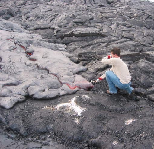 Matt Jackson, against his better judgement, engages the lava in a battle of wits. Matt succeeded in sampling a small bit of lava, but Pele claimed his eyebrows as a souvenir.