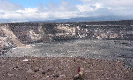Halemaumau Crater, shown here, sits within the larger Kilauea Caldera. It is the site of the most recent eruptive activity at the summit of Kilauea Volcano. In the foreground you can see offerings left to the volcano goddess Pele.