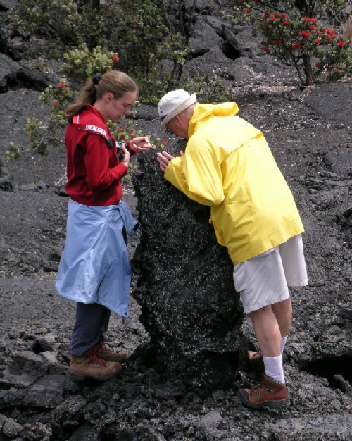 ad and Jessica Williams peer down a ?tree mold?. Tree molds form when active lava flows surround and quench against trees.