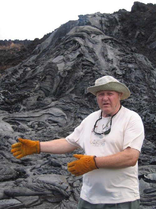 Hans Schouten offers us a great deal on what he tells us is some of the newest land on Earth. Hans is standing in front of the Hilina Pali (cliff), a fault that has formed due to deformation of Kilauea?s south flank.