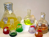 vividly colored culture flasks holding marine microbes from Waterbury Collection