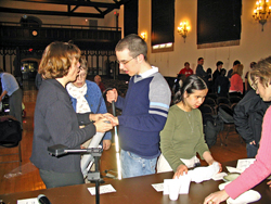 Dr. Bower explains how a deep-ocean sample bottle operates. The open pressure-proof bottle is attached to a cable that is gradually lowered into the water. An electronic signal sent from an on-deck unit instructs the bottle to close at a desired depth to collect water. This water can be analyzed for concentrations of salt, oxygen, and other properties, depending on the objectives of the experiment.  
