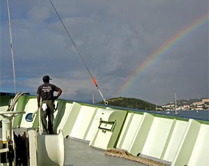 Bosun Clindor Cacho admires a rainbow as the Oceanus prepares to dock at St. Thomas