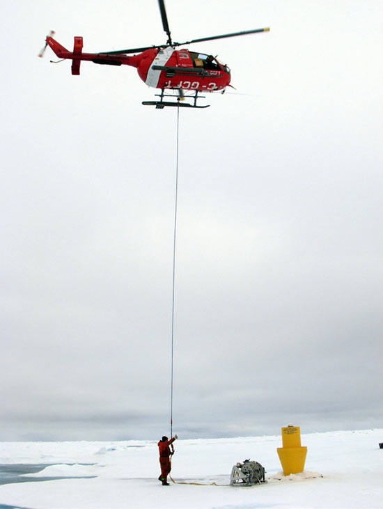attaches the helicopter sling to a winch for transport back to the icebreaker