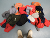 Pile of warm clothing set out on the floor.
