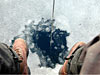 Peter Winsor peers into a hole cut into the ice