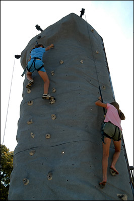 Children climbing the rock wall at the summer picnic 