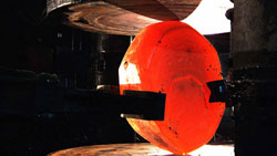 The 13,000-lb titanium billet is heated to 1,700 degrees Fahrenheit and �edge rolled� to get it as close to circular as possible. After that, it is paddled to flatten its diameter to 130 inches and to reduce its thickness to approximately six inches.