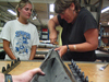 Amanda Uster (left) and Beth Christensen (right) opening a retrieved core on R/V Knorr.