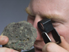 adam soule examining rock