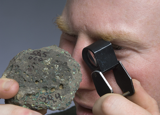 adam soule examining rock
