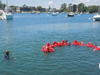 water safety students in Gumby suits form human chain to stay together in the water