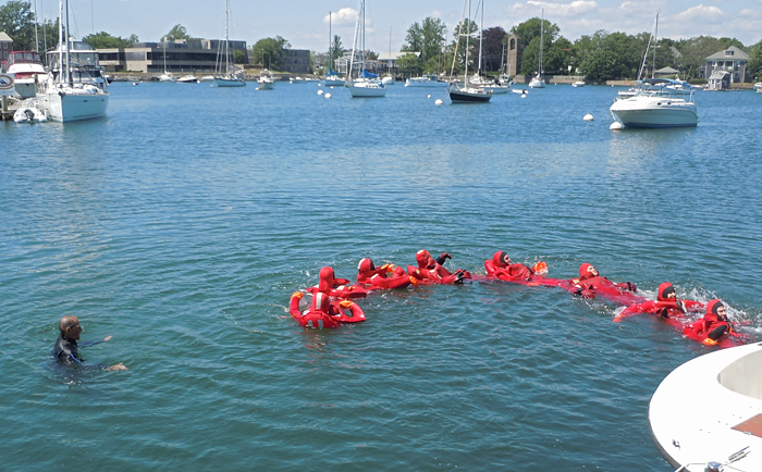 water safety students in Gumby suits form human chain to stay together in the water