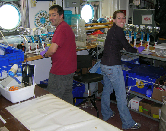 Tim Shanahan and Kim Popendorf working in the main lab of Oceanus.