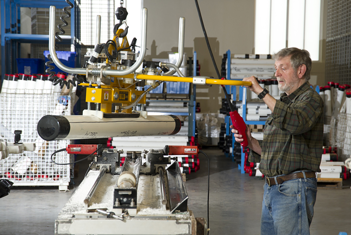 Researcher moves 1.5 meter long core to bench where it will be split.