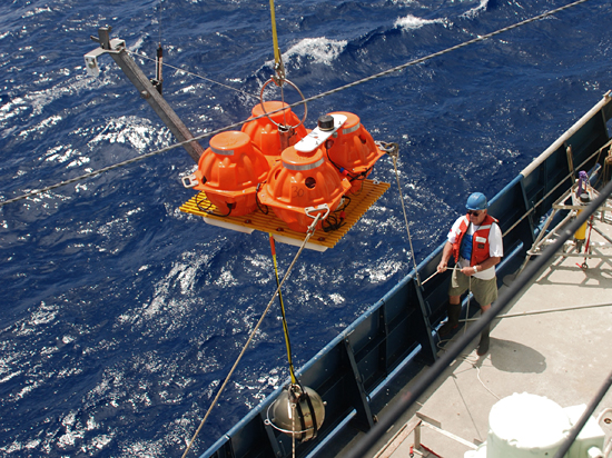 Engineering assistant Rob Handy handles a line during recovery of an ocean bottom seismometer (OBS) aboard R/V Atlantis in January 2009.  