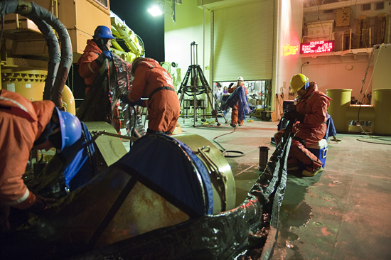 Crew on USCG Healy clean nets for zooplankton study