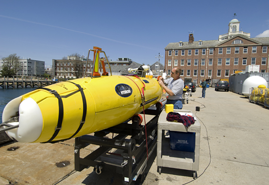 Engineer Bob Elder prepares the REMUS 6000 autonomous underwater vehicle for testing in the harbor of Woods Hole in May 2008. The AUV is headed to Estonia this summer for deep-ocean survey work in the Baltic Sea and other northern European waters.