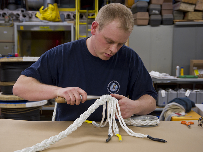 Engineering assistant Christopher Ross splices a 