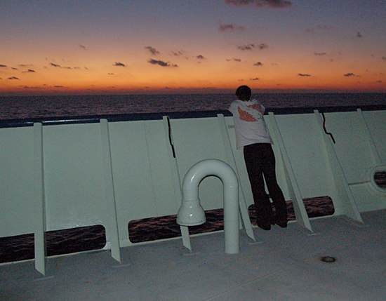 Nika Staglicic on open deck watching the sunrise on the LADDER 3 cruise.