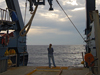 Skylar Bayer dwarfed by the R/V Atlantis A-frame.