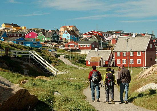 Sarah Das, center, and colleagues entering a village during the July 2007 expedition to Greenland.