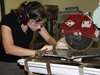 student cutting rock with table saw