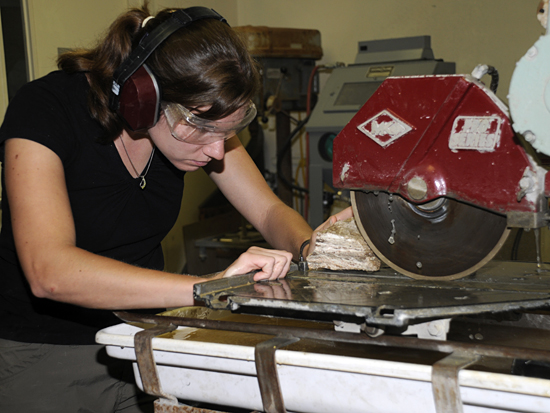 student cutting rock with table saw
