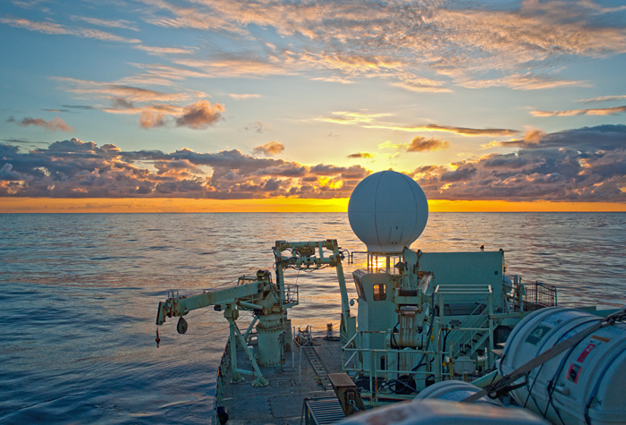 sunset at sea, looking over aft deck of RV Knorr