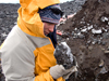 Adam Soule examining rock during Polar Discovery, Antarctica.