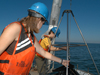 2007 Summer Student Fellows Tess Brandon and Kelsey Winsor deploy a box corer off the stern of R/V Tioga.