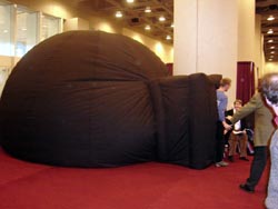 Scientists exit the inflatable planetarium
