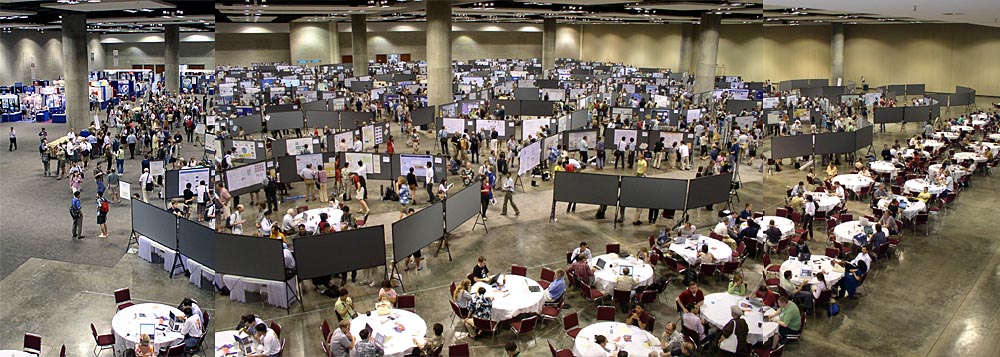 500 posters cram a cavernous meeting hall